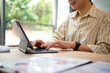 © jojo - The businessman is reviewing work on a tablet at his desk.