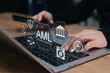 © Sandwish - AML Anti-Money Laundering concept. business person typing on laptop interacting with digital icons of financial law, fraud protection, compliance, regulations, transaction screening, crime prevention,