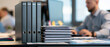 © Atchariya63 - Office binder paperwork desk file folder stack business document organized workspace coworker computer productivity record