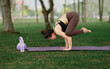 © Sunisa - An Asian girl practicing morning yoga outdoors to recharge her energy in an urban oasis.