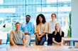 © we.bond.creations - Diverse business professionals feeling positive and collaborating in a modern coworking office environment, showcasing teamwork and success