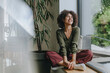 © Westend61 - Businesswoman relaxing near office window with a smile