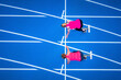 © VISTA by Westend61 - Top view of two female runners starting on tartan track