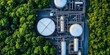 © Lexi - Design - Industrial storage facility with spherical tanks and pipeline system inside dense woodland.