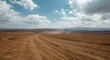 © pngking - Expansive dirt terrain with rolling hills and cloud filled sky highlighting open land for development potential