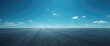 © NeuralNiche - Expansive asphalt surface under a clear vibrant sky with few clouds