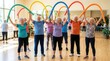 © ZHMPRO - Happy seniors exercising with colorful foam noodles during a fitness class in a community center, active aging.
