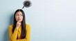 © Farhan - Anxious Young Asian Woman with Chaotic Scribble Thought Bubble Over Her Head