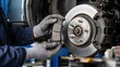 © Andrii  - Automotive Mechanic Replacing Brake Pads During Vehicle Maintenance and Repair Service