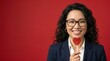 © Bima - Smiling Asian woman holding a heart-shaped lollipop on red background