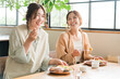© buritora - Women enjoying a delicious lunch with their female friends/mom friends (girls' get-together)