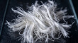© Creative_Tech - Fiberglass strands arranged in a messy pile display the raw texture and industrial potential of synthetic reinforcement materials for modern manufacturing.