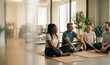 © Graphix - Diverse corporate coworkers laughing together during a mindfulness yoga break in a sunlit modern office, copy space