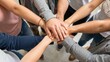 © rahwik - Close up top view of young people putting their hands together. Friends with stack of hands showing unity and teamwork.