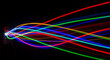 © tu - Prismatic luminous spectrum gradient leak displaying defocused abstract glow and radiant color blending on dark black background featuring ethereal optical beam neon flare effects.