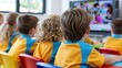 © The Little Hut - Diverse young students engaged in learning, watching educational content on a large screen in a modern classroom setting