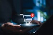 © MstTasmiya - Online shopping cart and e-commerce purchase concept. Person using smartphone and laptop with cart icon, item notification, mobile checkout, digital retail, order process, and online buying experience