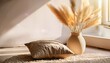 © Courtney - cozy interior corner with soft pillow fluffy rug and decorative vase with dried grass in warm sunlight minimal home decor scene with calm relaxing atmosphere