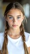 © GEGE - A young girl with braided hair and a white shirt