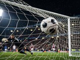 Soccer ball hitting the net in a stadium at night