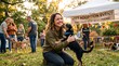© irawan - Happy woman hugging a puppy at a pet adoption event in a park
