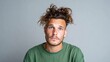 © svastix - A young man with messy curly hair and striking blue eyes looks thoughtfully into the camera, capturing a moment of introspection and emotional depth in a minimalist setting.