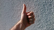 © Алексей Иванченко - hand with thumb up,Close up of male thumbs up.Positive hand gesture in bright sunlight.Success and approval sign against wall.Minimalist human hand giving a like