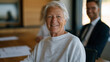 © forenna - Elderly retiring founder meets with adult children and a legal advisor at a long oak conference table, succession documents spread across the surface as family business ownership transfers formally