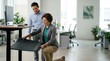 © spyrakot - Ergonomics specialist adjusting standing desk mat in modern office