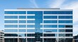 © Latsamee - Modern office building featuring contemporary corporate architecture with large glass windows and polished steel on the exterior facade, design, company, polished