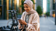 © Kateryna - A confident Middle Eastern woman in a soft elegant abaya operates softly a bright electric scooter app on a calm modern street corner in natural daylight scooter app open face