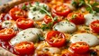 © Kui - Vegetarian pizza with cherry tomatoes and melted mozzarella, garnished with fresh herbs.