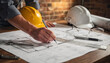 © Hanskie28 - Engineer Working On Architectural Blueprints With Construction Safety Equipment In Modern Office