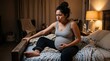 © Fiverr/fazilazia703 - Pregnant woman in pain holding her belly while sitting on a bed in a dimly lit bedroom with warm lamp light, experiencing contractions or early labor, conveying maternal health concepts.