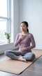 © Fernando - Young Asian Woman Practicing Mindfulness and Deep Breathing Exercise on Yoga Mat