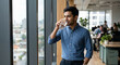© Shadhin_GFX - Thoughtful young male professional drinking water by large window in modern office
