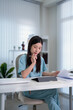 © Pichsakul - Asian woman doctor working on paperwork reviewing medical report document at home office desk holding pen thinking professional healthcare worker studying