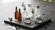 © raza - Set of professional skincare cosmetic bottles and jars on a wet black stone surface with water drops
