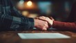 © vetrana - Two people hold hands at a table in a cafe