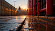 © sunflower24 - Wet pavement reflecting sunset light near red pipes and industrial structures creating warm, moody urban atmosphere