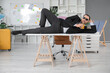 © Pixel-Shot - Happy male office worker in sunglasses lying on table and drinking cocktail in office. Summer vacation concept
