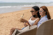 © Art_Photo - Happy lesbian couple drinking cocktail on the beach during summer vacation, Two smiling women in love enjoying travel and relaxing holiday together, LGBT diversity and romantic relationship concept