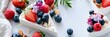 © Anat art - Cheesecake slices with fresh berries and nuts arranged on a white surface with natural light highlighting the luxury wellness setting