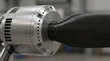 © Andrey - Close-up of sleek electric air taxi rotor blade during takeoff, showcasing carbon fiber texture and metallic engine details in a modern workshop setting