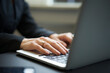 © Westend61 - Businesswoman's hands typing on laptop in office