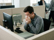 © DIAN - Unwell Office Worker Sneezes At His Desk During A Pandemic Outbreak Scenario