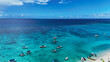 © AmazingAerialAgency - Aerial view of boats anchored in the turquoise water along the white sand beach under a clear blue sky Trou-aux-Biches, Pamplemousses District, Mauritius.