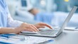 © Crealif76 - Medical professional using laptop in clinical setting for patient care documentation