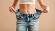 © Hathairat - Woman weight loss loose jeans slim waist flat stomach body transformation diet fitness