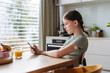 © Halfpoint - Teen girl with diabetes scanning glucose level using CGM sensor and smartphone.